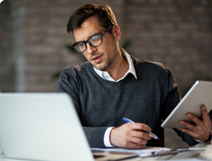 Reviewing a project scope on a laptop and tablet